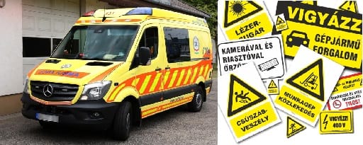 Sárga mentőautó és figyelmetzető táblák